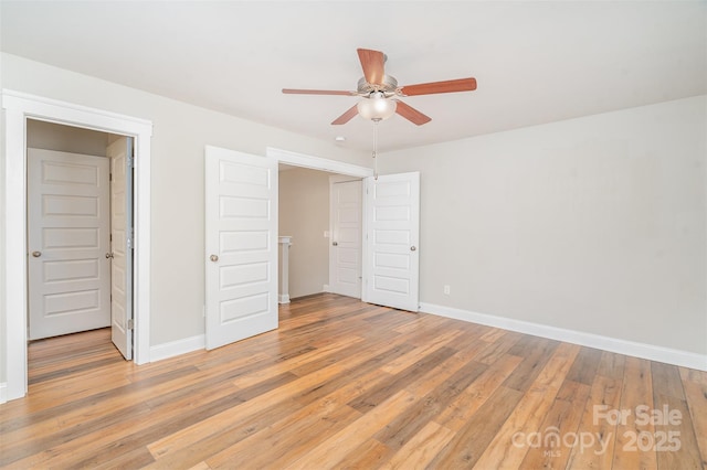 unfurnished bedroom with a ceiling fan, light wood-style flooring, and baseboards