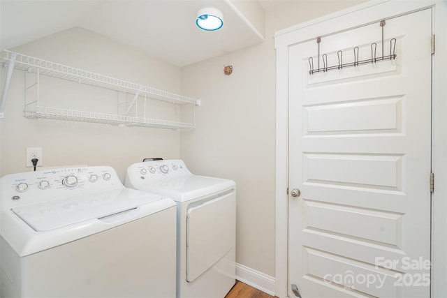 laundry area featuring light wood-style floors, laundry area, baseboards, and washing machine and clothes dryer