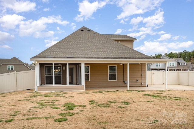 back of house featuring a shingled roof, a patio area, and a fenced backyard