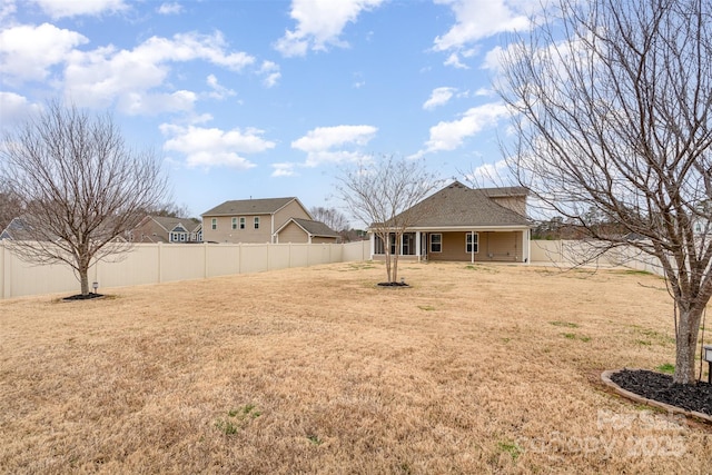 view of yard with a fenced backyard