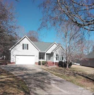 view of front facade featuring concrete driveway and an attached garage