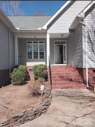 doorway to property featuring covered porch