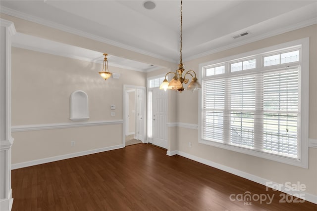 unfurnished dining area featuring visible vents, baseboards, an inviting chandelier, crown molding, and wood finished floors