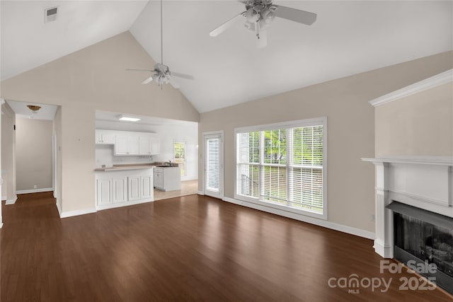 unfurnished living room featuring high vaulted ceiling, visible vents, a ceiling fan, and wood finished floors