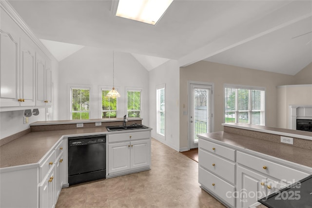kitchen featuring black dishwasher, a sink, vaulted ceiling, and plenty of natural light