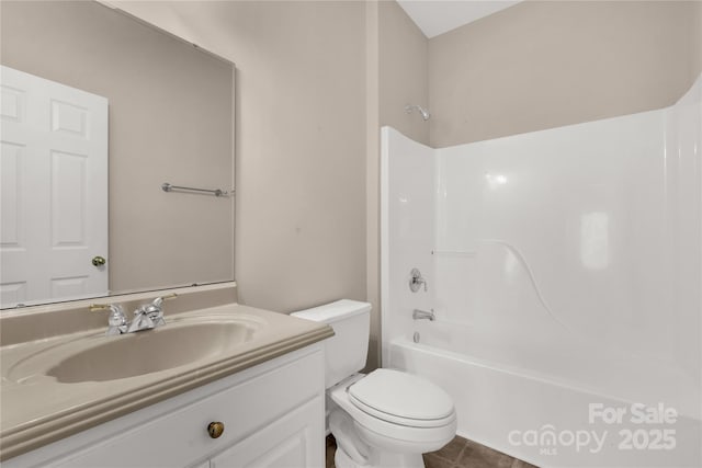 bathroom featuring tile patterned floors, toilet, shower / bathing tub combination, and vanity