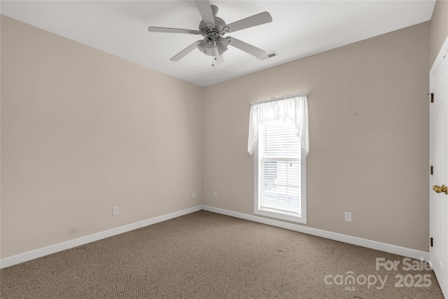 carpeted empty room featuring visible vents, baseboards, and a ceiling fan