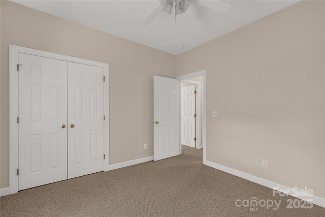 unfurnished bedroom with carpet floors, baseboards, a ceiling fan, and a closet