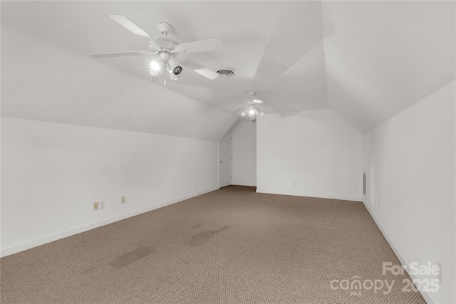 additional living space featuring visible vents, light colored carpet, ceiling fan, and vaulted ceiling