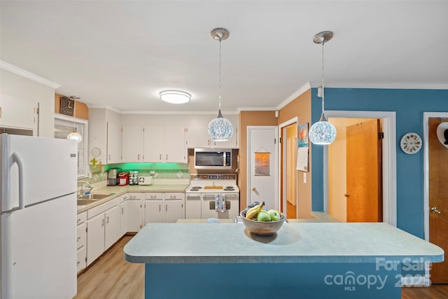 kitchen featuring white appliances, a sink, and white cabinets