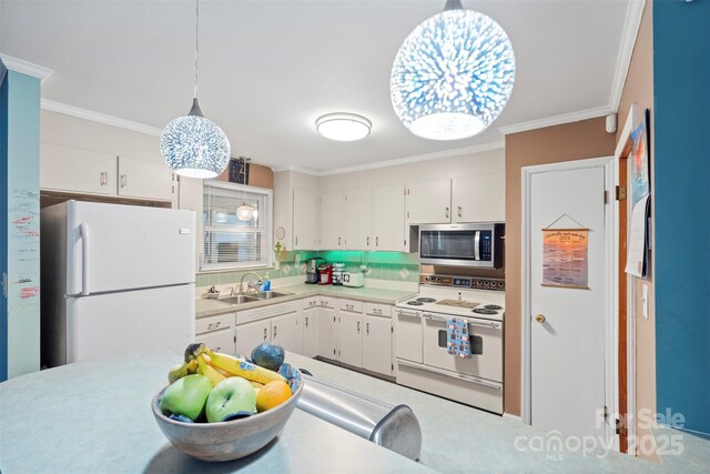 kitchen with crown molding, light countertops, white cabinetry, a sink, and white appliances