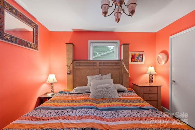 bedroom featuring a notable chandelier