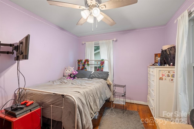 bedroom with ceiling fan and wood finished floors