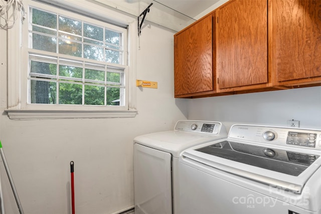 washroom with cabinet space and washing machine and clothes dryer