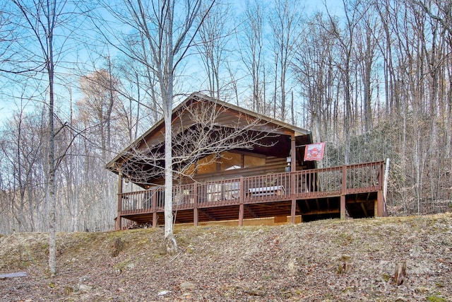 rear view of house featuring a forest view