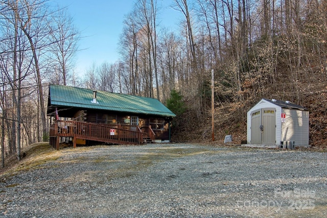 exterior space featuring an outbuilding, metal roof, and a shed