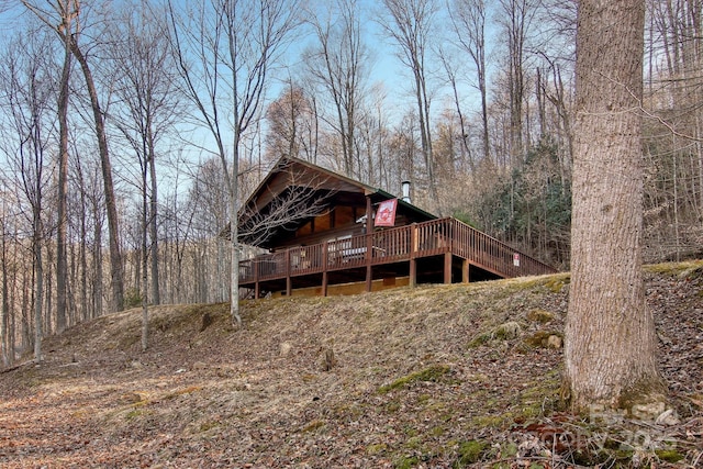 back of property featuring a wooden deck