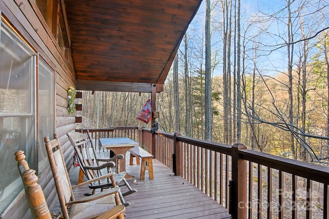 wooden deck with a view of trees