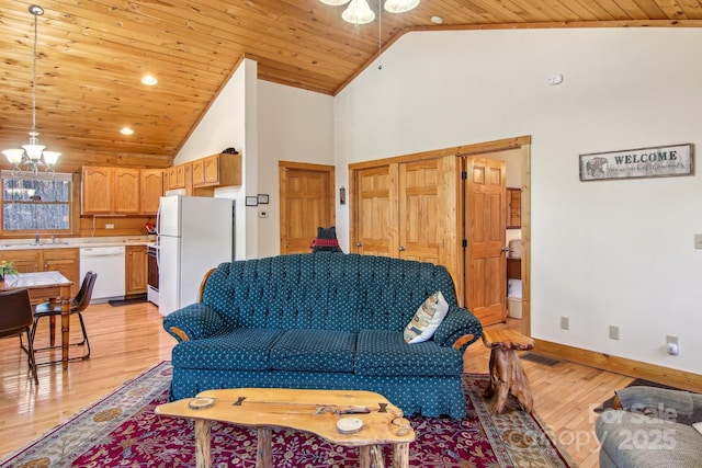 living room with light wood-style floors, wood ceiling, and a notable chandelier