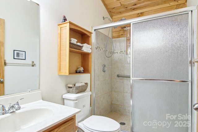 full bathroom featuring toilet, vanity, and a shower stall