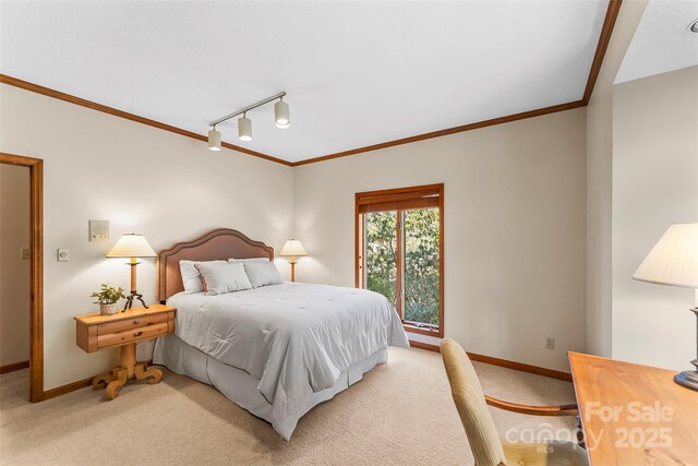 bedroom featuring crown molding, baseboards, light colored carpet, and track lighting