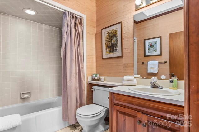bathroom featuring vanity, tile patterned floors, toilet, and shower / bath combination with curtain