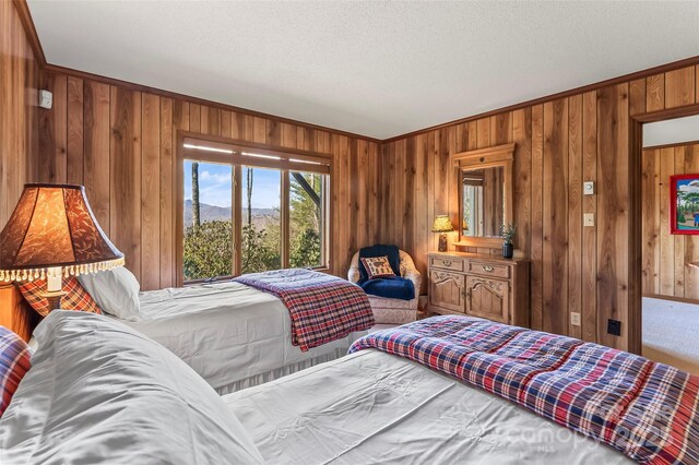 bedroom featuring crown molding and wood walls