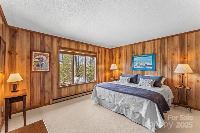 carpeted bedroom with wood walls, ornamental molding, baseboards, baseboard heating, and a textured ceiling