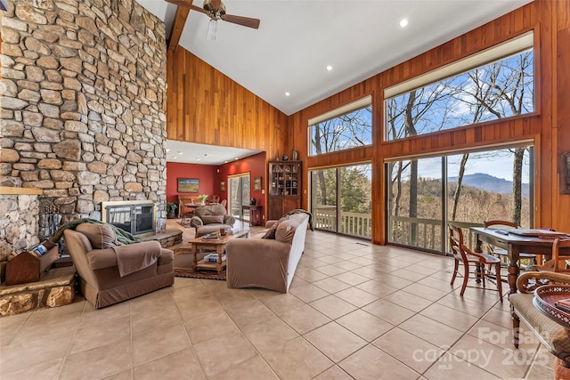 243 Red Oak Trl, Boone, NC 28607 - living area featuring high vaulted ceiling, a fireplace, light tile patterned floors, wooden walls, and a ceiling fan