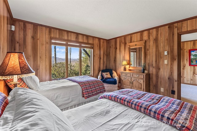 243 Red Oak Trl, Boone, NC 28607 - bedroom featuring wood walls, crown molding, a mountain view, and a textured ceiling