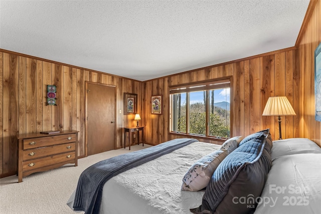 243 Red Oak Trl, Boone, NC 28607 - bedroom featuring light carpet, wood walls, a textured ceiling, and ornamental molding