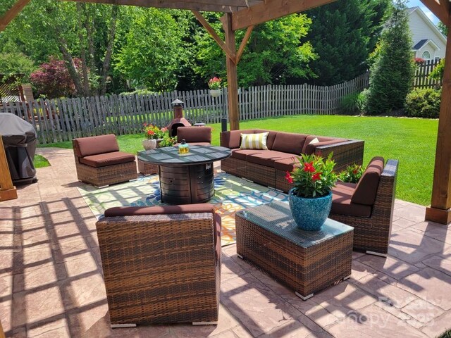 view of patio / terrace featuring a pergola, a fenced backyard, grilling area, and an outdoor hangout area