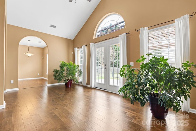 entryway with high vaulted ceiling, french doors, visible vents, and wood finished floors