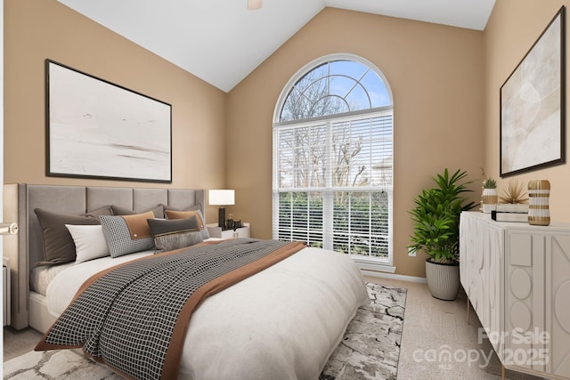 bedroom featuring carpet, multiple windows, vaulted ceiling, and baseboards