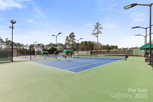 view of sport court featuring fence