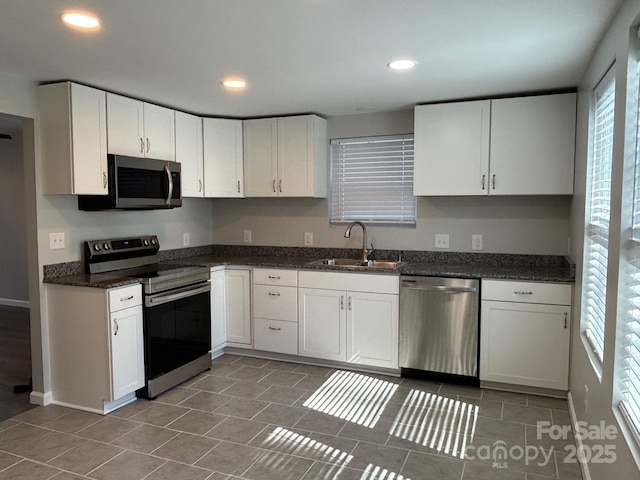 kitchen featuring white cabinetry, appliances with stainless steel finishes, a sink, and recessed lighting