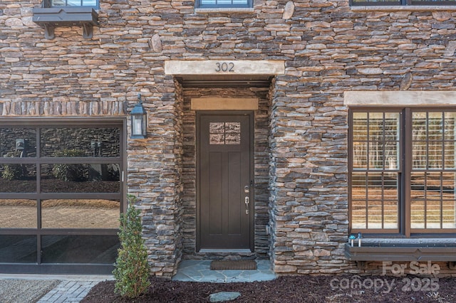 doorway to property with stone siding