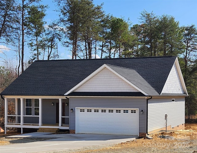 view of front of home with an attached garage, covered porch, concrete driveway, and crawl space