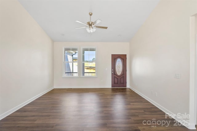 entrance foyer featuring a ceiling fan, lofted ceiling, dark wood-style flooring, and baseboards