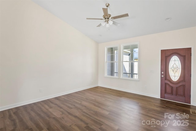 entrance foyer featuring dark wood-type flooring, vaulted ceiling, baseboards, and a ceiling fan