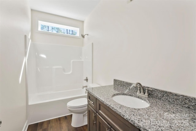 full bath featuring toilet, bathing tub / shower combination, wood finished floors, and vanity