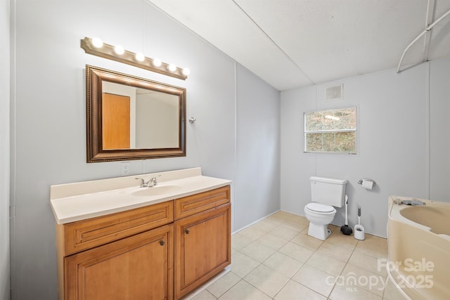 full bath featuring a bathtub, visible vents, toilet, vanity, and tile patterned floors