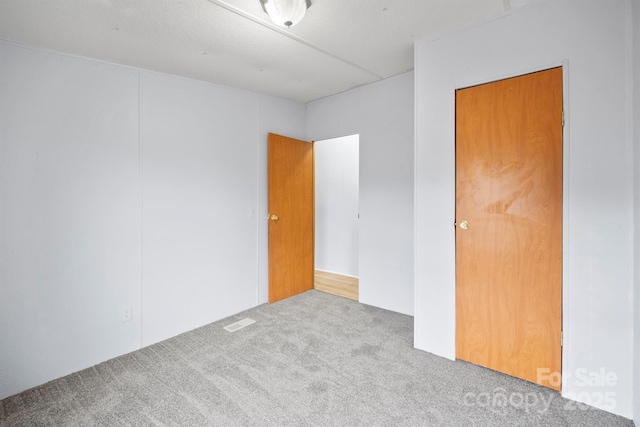 empty room featuring carpet and visible vents