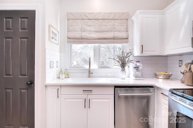 kitchen with decorative backsplash, a sink, and light countertops