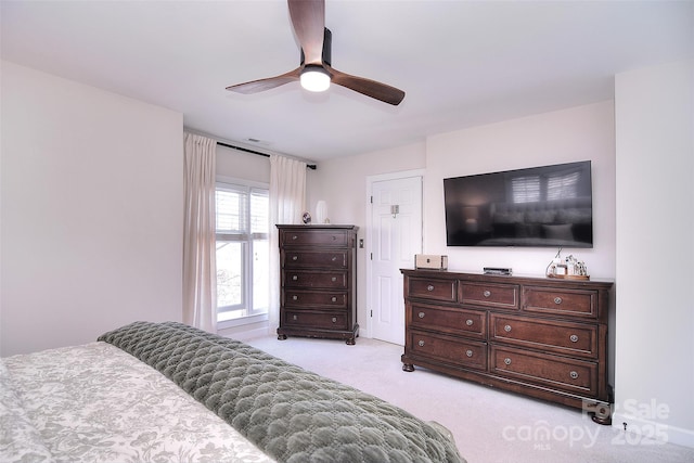 bedroom featuring a ceiling fan and light colored carpet