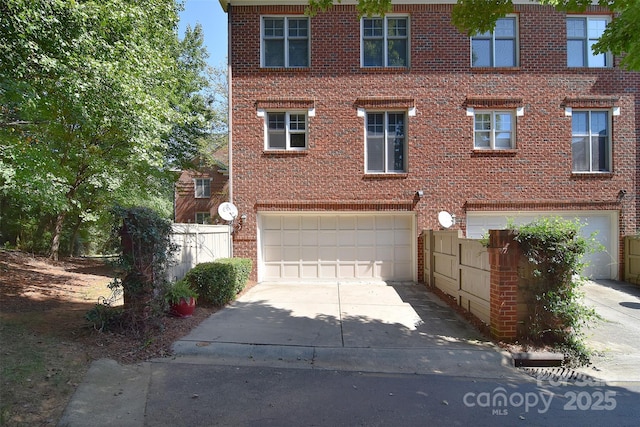 view of front of property featuring concrete driveway, brick siding, and an attached garage