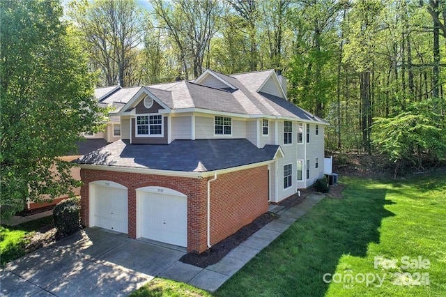 view of property exterior featuring concrete driveway, brick siding, a yard, and central AC unit