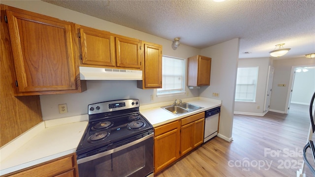 kitchen featuring under cabinet range hood, a sink, light countertops, stainless steel electric stove, and dishwasher