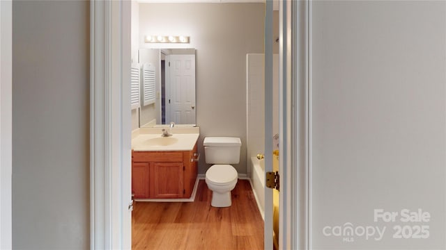 full bath with wood finished floors, vanity, toilet, and shower / bathing tub combination