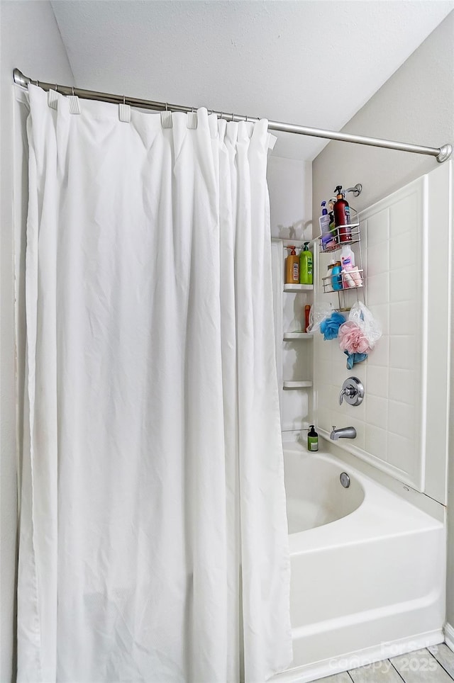 full bathroom featuring shower / bath combination with curtain and tile patterned floors